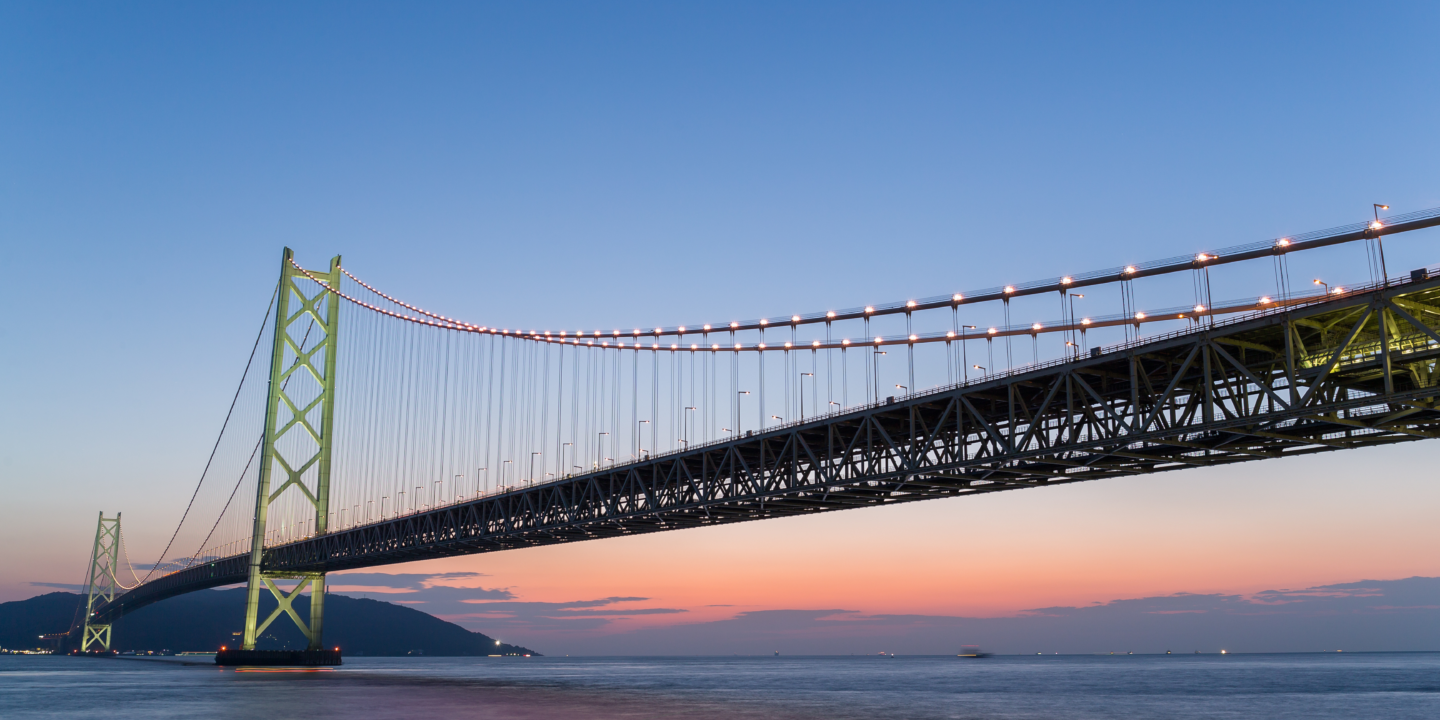 The Akashi Kaikyo Bridge, a suspension bridge in Japan, at dusk.