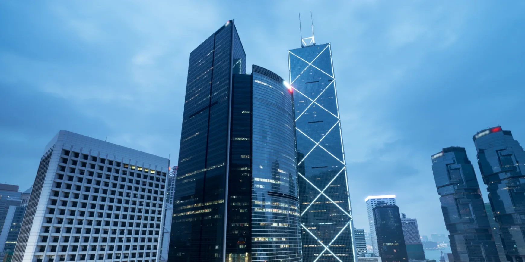 Modern skyscrapers in a city financial district at dusk, representing business growth and financial success.